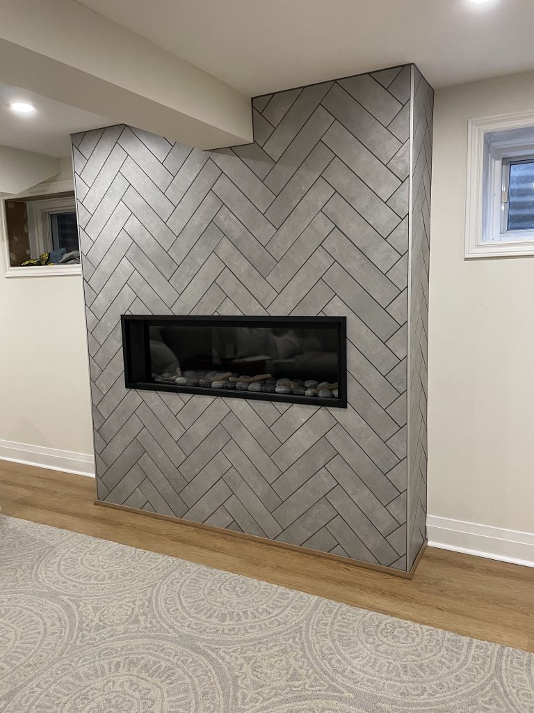 Toronto custom built in gas fireplace surround herringbone tile